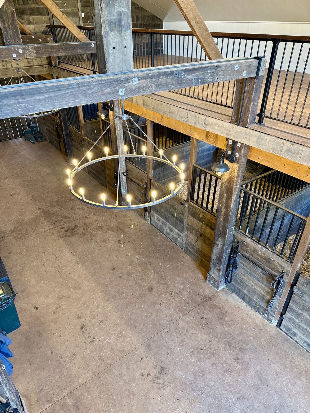 Stable aisle seen from the loft, with a chandelier